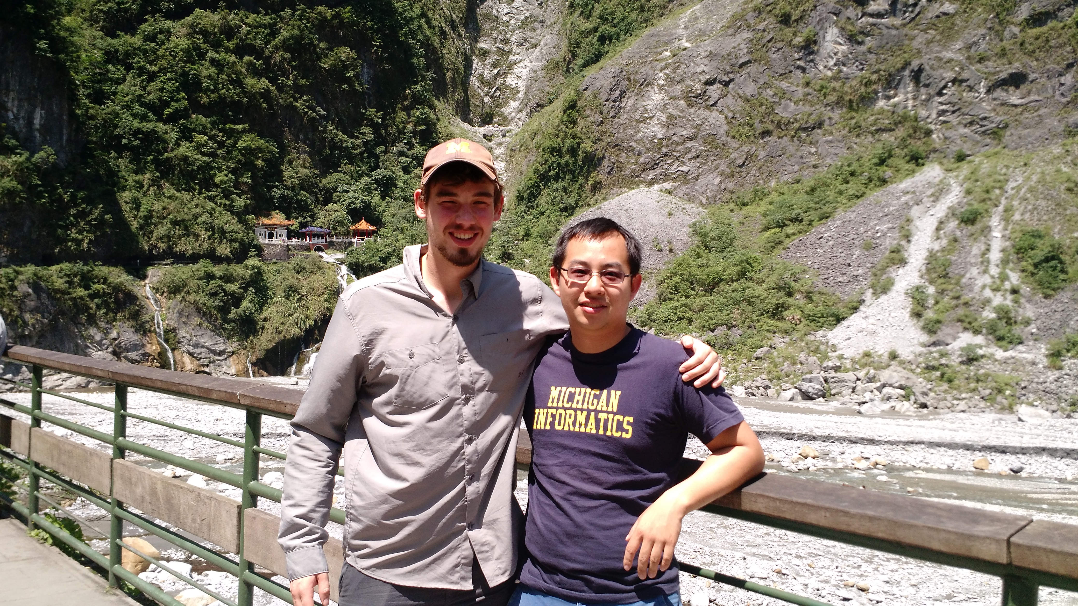 Andy and I on a bridge with a memorial to the fallen 200 workers in the backdrop